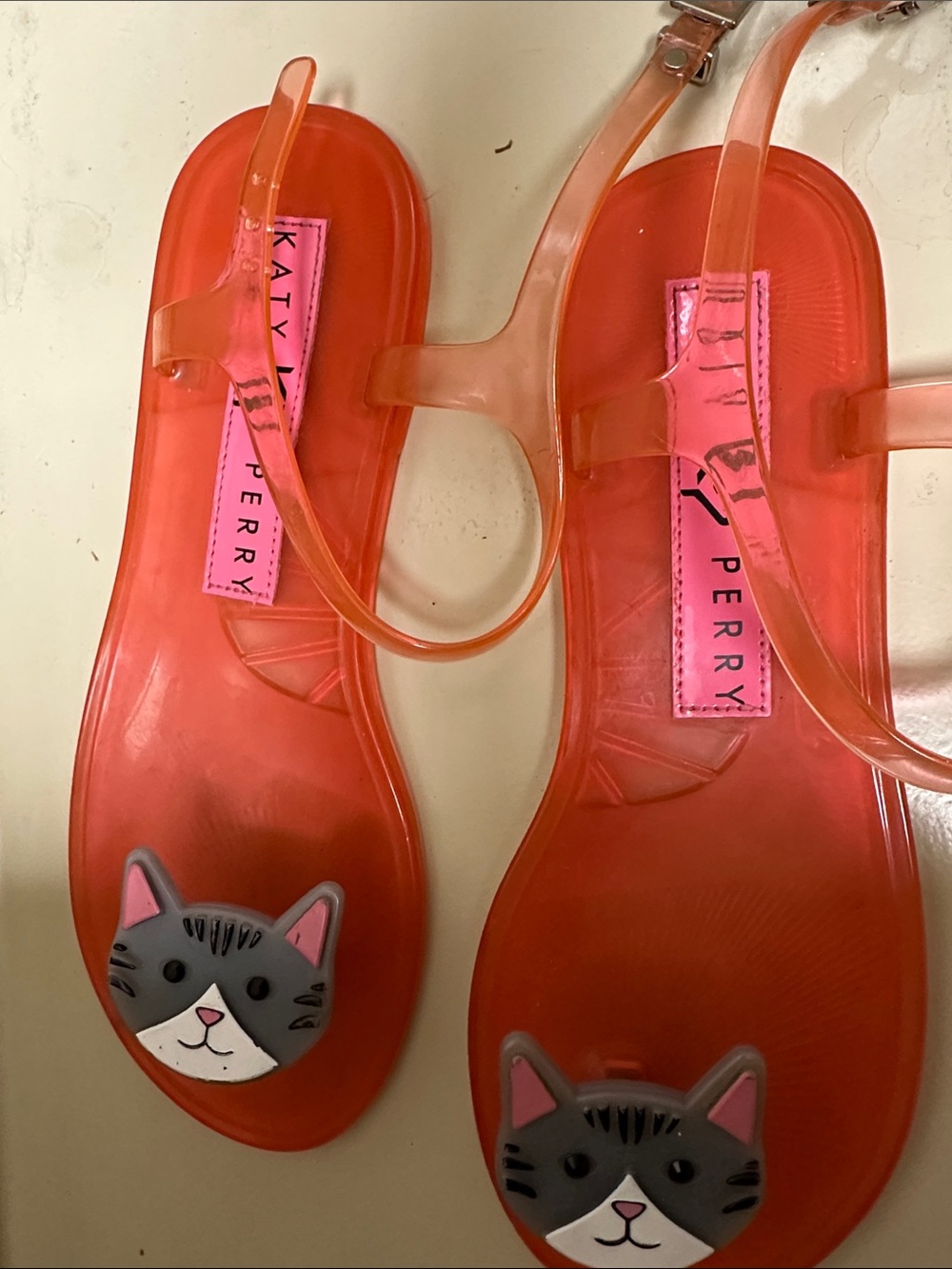 Katy Perry Collections pinkish red jelly sandals with gray cat toe